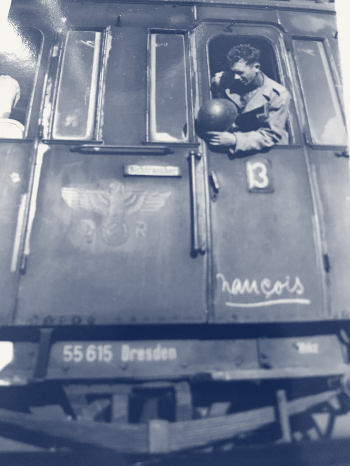 Papa as a young soldier, leaning out of the window of a German railroad car marked 55615 Dresden